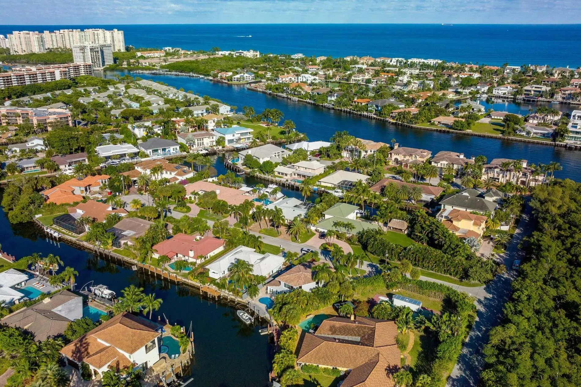 Aerial view of waterfront homes in Caribbean Keys Boca Raton with canals, tropical landscaping, and ocean access.